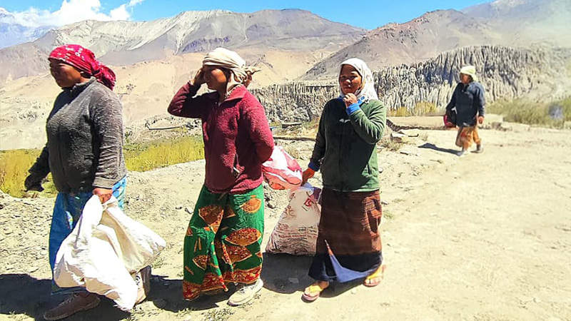 Women leaving to tend fields left behind by migrating household members in Mustang